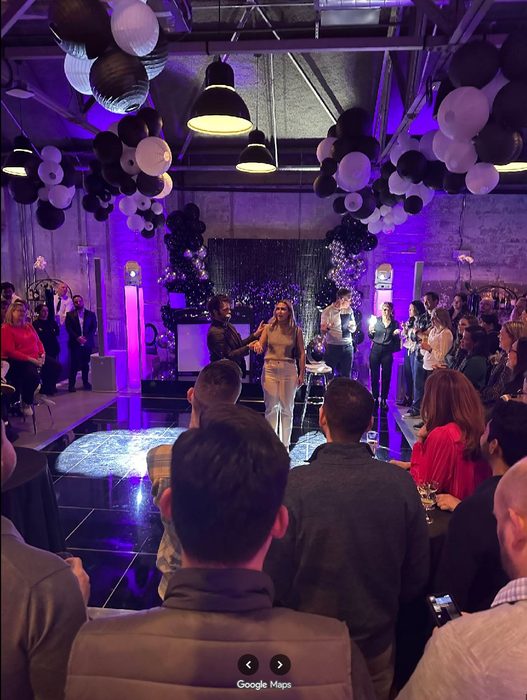 Guests at an event Kent Axell performed at, under purple lighting